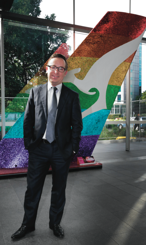 Qantas chief executive Alan Joyce in front of the "rainbow roo" that appeared on his airline's Sydney Gay and Lesbian Mardi Gras parade float. The rainbow tail is now a fixture in the Qantas HQ foyer. (PHOTO: Ann-Marie Calilhanna; Star Observer)