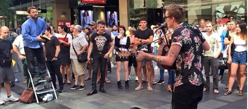Anti-gay preacher drowned out by street buskers on day of Mardi Gras Parade