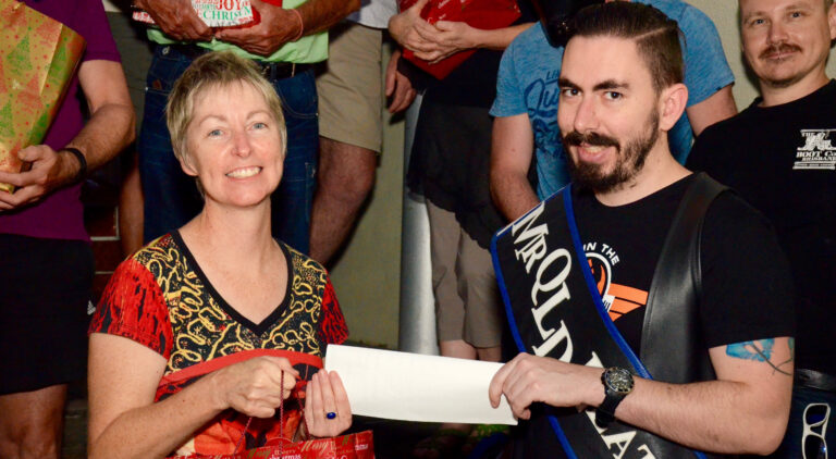 Ann Matson and Mr Queensland Leather David Eisentraut handing over the cheque. (PHOTO: David Alexander; Star Observer)