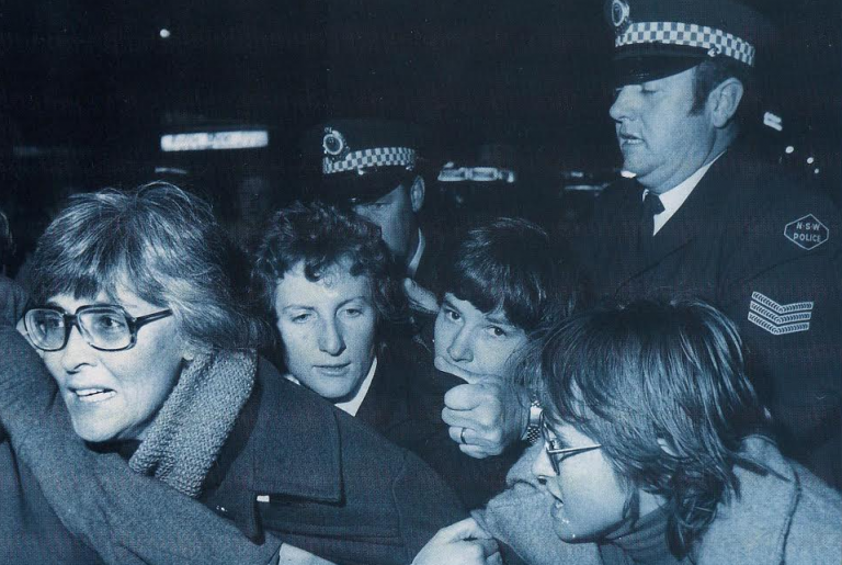 Gail Hewison (far left) just seconds before arrest at the first Mardi Gras in 1978. She said the police officer behind grabbed her by her hair and dragged her across the road and tossed her head first into paddy wagon. (Image supplied by Gail Hewison)
