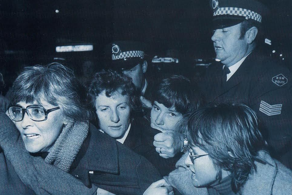 Gail Hewison (far left) just seconds before arrest at the first Mardi Gras in 1978. She said the police officer behind grabbed her by her hair and dragged her across the road and tossed her head first into paddy wagon. (Image supplied by Gail Hewison)
