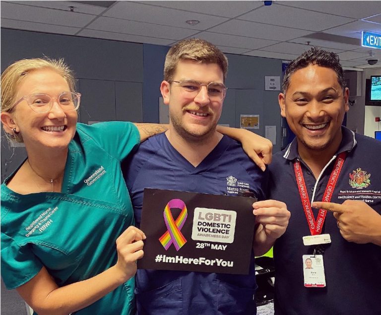 doctors and nurses at the Royal Brisbane & Women’s Hospital hold up placard for LGBTQ Domestic Violence Awareness Day